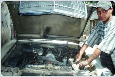 This 15 year old earns a living as a car mechanic in Ein el Hilweh refugee camp in southern Lebanon. Ein el Hilweh is Lebanon’s largest refugee camp – over 40,000 people live there.